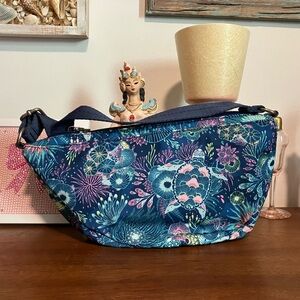 Sakroots Tess Sling bag in the Deep Teal Seascape pattern